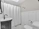 Neutral bathroom featuring a vanity with round basin sink, patterned tile floor, and combination shower and tub at 8621 Manderley Dr, Indianapolis, IN 46240