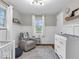 Bright Bedroom with a rocker, wainscoting, modern ceiling fixture and windows providing natural light at 8621 Manderley Dr, Indianapolis, IN 46240