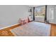 Bright bedroom with wood floors, area rug, window providing natural light and a closet with mirrored door at 8621 Manderley Dr, Indianapolis, IN 46240