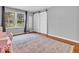 Bedroom with wood floors, area rug, a large window providing natural light and a sliding barn door at 8621 Manderley Dr, Indianapolis, IN 46240