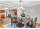 Elegant dining room with a wooden table, black chairs, and an open view to the kitchen and living areas at 8621 Manderley Dr, Indianapolis, IN 46240