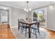 Stylish dining room with a wooden table, black chairs, and sliding glass doors to the backyard deck at 8621 Manderley Dr, Indianapolis, IN 46240