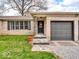 Inviting front entrance with a stone walkway, a wreath on the door, and an attached two-car garage at 8621 Manderley Dr, Indianapolis, IN 46240