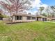 Beautifully landscaped yard with a single-story home featuring a stone facade and a two-car garage at 8621 Manderley Dr, Indianapolis, IN 46240