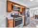 Kitchen with stainless steel appliances and wood cabinets, seamlessly blending functionality and style at 8621 Manderley Dr, Indianapolis, IN 46240