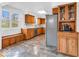 Well-lit kitchen featuring tile floors, wooden cabinets, stainless steel appliances, and ample counter space at 8621 Manderley Dr, Indianapolis, IN 46240