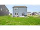 View of the home's backyard and patio area with seating and sliding door at 8694 Moyer Pl, Pendleton, IN 46064