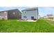 View of the home's backyard and patio area with seating and sliding door at 8694 Moyer Pl, Pendleton, IN 46064