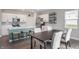 Bright kitchen and dining area featuring white cabinets, stainless steel appliances, and seating for four at 8694 Moyer Pl, Pendleton, IN 46064