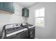 Modern laundry room with washer, dryer and storage at 8694 Moyer Pl, Pendleton, IN 46064