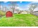 Spacious backyard features a shed, a gentle stream, and lush green lawn, perfect for outdoor activities at 9055 Panorama Ct, Indianapolis, IN 46234