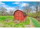 Charming red shed with brick steps, weather vane, and a backdrop of lush greenery at 9055 Panorama Ct, Indianapolis, IN 46234