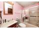 Functional pink bathroom featuring a combined shower and tub, toilet, and vanity with mirror at 9055 Panorama Ct, Indianapolis, IN 46234