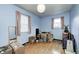 Blue bedroom with hardwood floors, two windows, and space to store belongings at 9055 Panorama Ct, Indianapolis, IN 46234