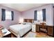 Comfortable bedroom features hardwood floors, natural light, neutral walls and a wood bedframe creating a serene space at 9055 Panorama Ct, Indianapolis, IN 46234