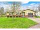 Charming single-story home with well-maintained lawn, brick accents, attached garage and flowering tree in front yard at 9055 Panorama Ct, Indianapolis, IN 46234
