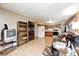 Inviting living room flows into the kitchen, featuring hardwood floors, brown sofa, bookshelf, and white appliances at 9055 Panorama Ct, Indianapolis, IN 46234