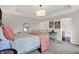 Cozy bedroom featuring a trey ceiling, stylish decor, and an ensuite bathroom at 967 Orlando St, Carmel, IN 46032