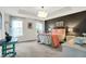 Bright and inviting bedroom with a decorative light fixture and a bold accent wall at 967 Orlando St, Carmel, IN 46032