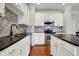 Well-lit kitchen featuring white cabinets, stainless steel appliances, and a beautifully tiled backsplash at 967 Orlando St, Carmel, IN 46032