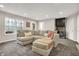 A spacious living room features an L-shaped sofa, with access to an outdoor patio through a glass door at 967 Orlando St, Carmel, IN 46032