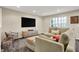 Living room with comfortable seating, media center, and a bright window, offering a relaxing space at 967 Orlando St, Carmel, IN 46032