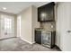 Living room with a beverage center, cabinet storage, and a view to the outdoor living space at 967 Orlando St, Carmel, IN 46032