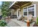Back patio area with wood chairs and outdoor seating, perfect for relaxation and enjoying nature at 967 Orlando St, Carmel, IN 46032