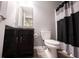 Modern bathroom with dark vanity, neutral walls, and matching black and white shower curtain for a sleek design at 9770 Blue Violet Dr, Noblesville, IN 46060