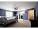 Spacious bedroom with a full bathroom, dark furniture, and plenty of natural light, offering a private oasis at 9770 Blue Violet Dr, Noblesville, IN 46060