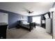 Elegant bedroom with a dark wood bed, television, and calming blue walls providing a peaceful retreat at 9770 Blue Violet Dr, Noblesville, IN 46060