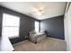 Comfortable bedroom with neutral carpet, two windows offering ample sunlight, and a convenient ceiling fan at 9770 Blue Violet Dr, Noblesville, IN 46060