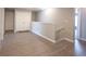 Bright hallway with wood-look floors, white trim, closet and an open doorway leading to another room at 9770 Blue Violet Dr, Noblesville, IN 46060