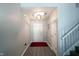 Well-lit hallway with staircase and access to multiple rooms at 9770 Blue Violet Dr, Noblesville, IN 46060