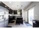 Open-concept kitchen featuring an island with seating and stainless steel appliances at 9770 Blue Violet Dr, Noblesville, IN 46060
