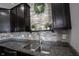 Close up of kitchen with decorative backsplash and stainless steel sink at 9770 Blue Violet Dr, Noblesville, IN 46060