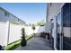 Fenced in patio with flower pots, greenery and sliding glass door at 9770 Blue Violet Dr, Noblesville, IN 46060