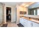 This bathroom features double sinks, walk-in shower, and separate walk in closet at 9812 Logan Ln, Fishers, IN 46037