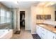 Bright bathroom with double vanity, separate glass shower, soaking tub, and walk-in closet at 9812 Logan Ln, Fishers, IN 46037