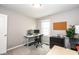 This bedroom features a computer desk setup, with an office chair, dual monitors and a window at 9812 Logan Ln, Fishers, IN 46037