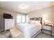 Bedroom with a neutral color scheme and stylish accents, including a decorative bench and silhouette art at 9812 Logan Ln, Fishers, IN 46037