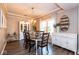 Formal dining room with modern chandelier, dark wood table set for six, and stylish decor at 9812 Logan Ln, Fishers, IN 46037