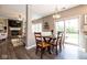 Elegant dining area featuring a modern chandelier, seamless access to the kitchen and living room, and a sliding glass door at 9812 Logan Ln, Fishers, IN 46037