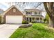 Charming two-story home featuring a brick and siding exterior, attached garage, and covered front porch at 9812 Logan Ln, Fishers, IN 46037