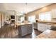 Open-concept kitchen featuring granite countertops, a center island, stainless steel appliances, and seamless access to living area at 9812 Logan Ln, Fishers, IN 46037