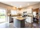 Bright kitchen featuring granite countertops, stainless steel appliances, a gray center island, and subway tile backsplash at 9812 Logan Ln, Fishers, IN 46037