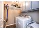 Convenient laundry room equipped with a washer, dryer, overhead storage, and a mounted vacuum at 9812 Logan Ln, Fishers, IN 46037