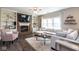 Bright living room with fireplace, built-in shelves, and a plush white sectional couch at 9812 Logan Ln, Fishers, IN 46037