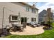 A beautiful outdoor patio features lounge chairs, a dining table, and a grill with string lights overhead at 9812 Logan Ln, Fishers, IN 46037