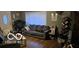 Comfortable living room with hardwood flooring, a plush grey sofa, and natural light from the front door at 1006 Columbia Ave, Alexandria, IN 46001